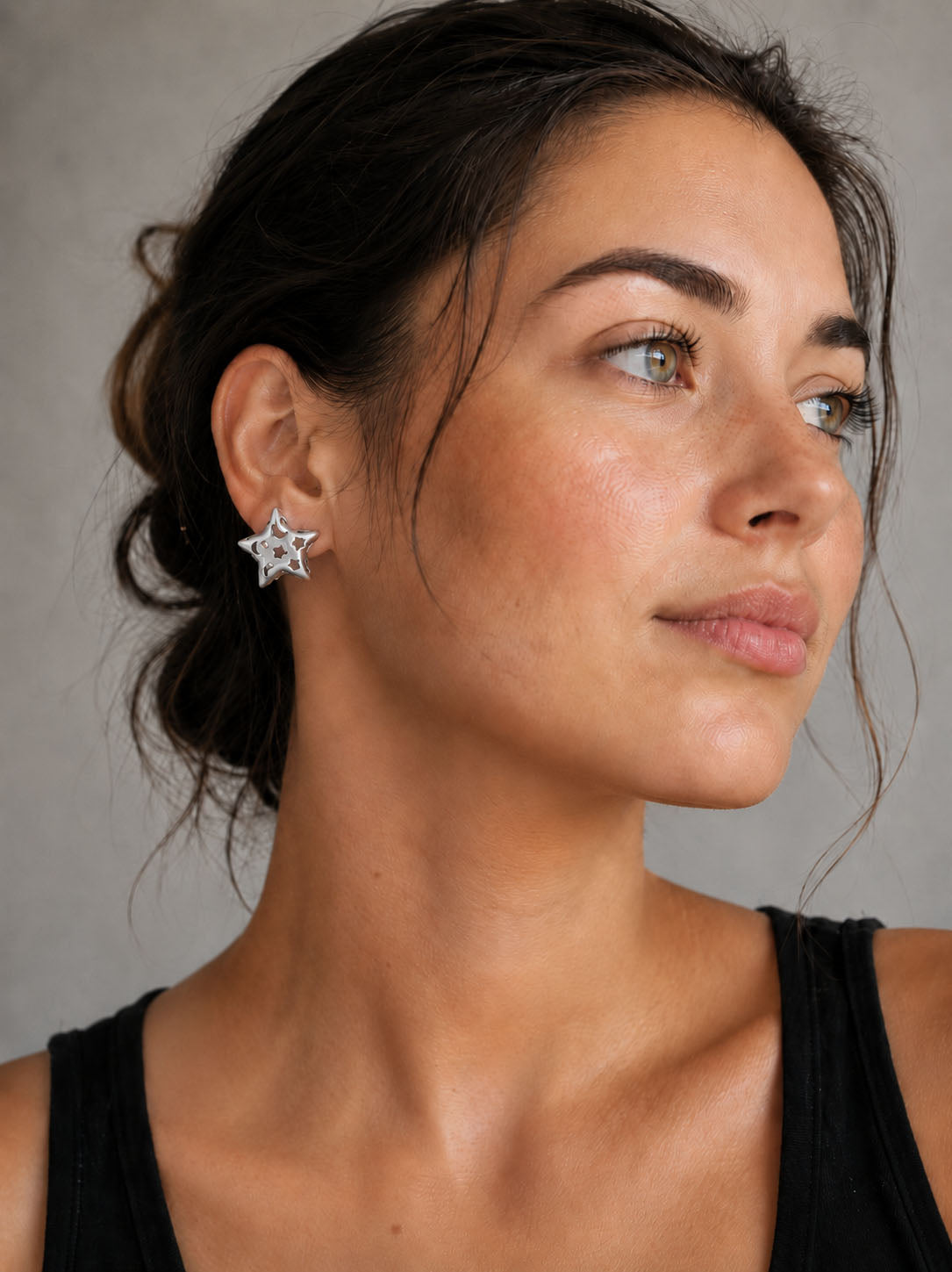silver-plated hollow star stud earrings with cutout details and polished modern minimalist design
