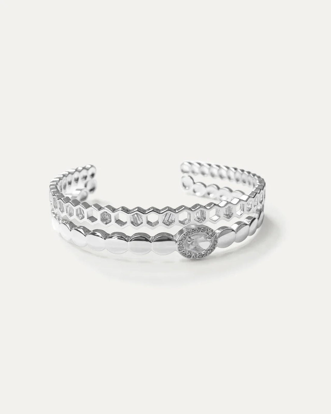 Silver openwork ring on a light gray background