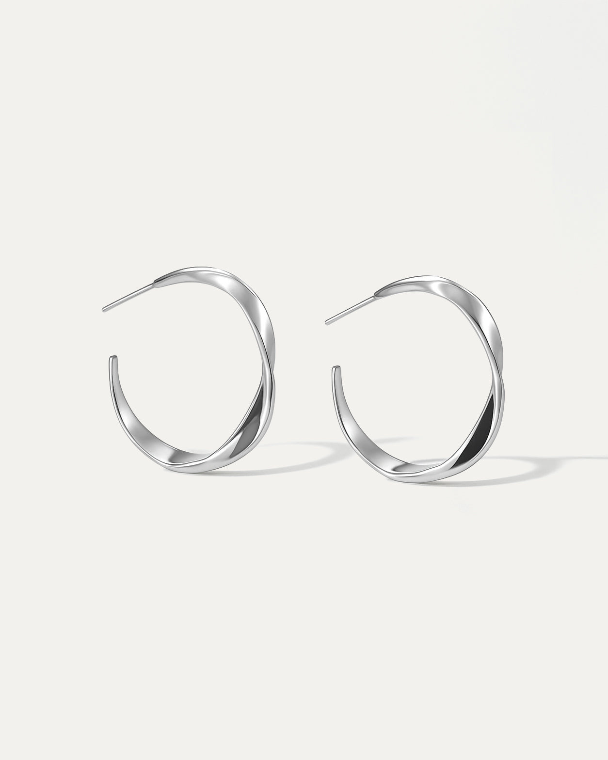 Pair of silver hoop earrings on a white background