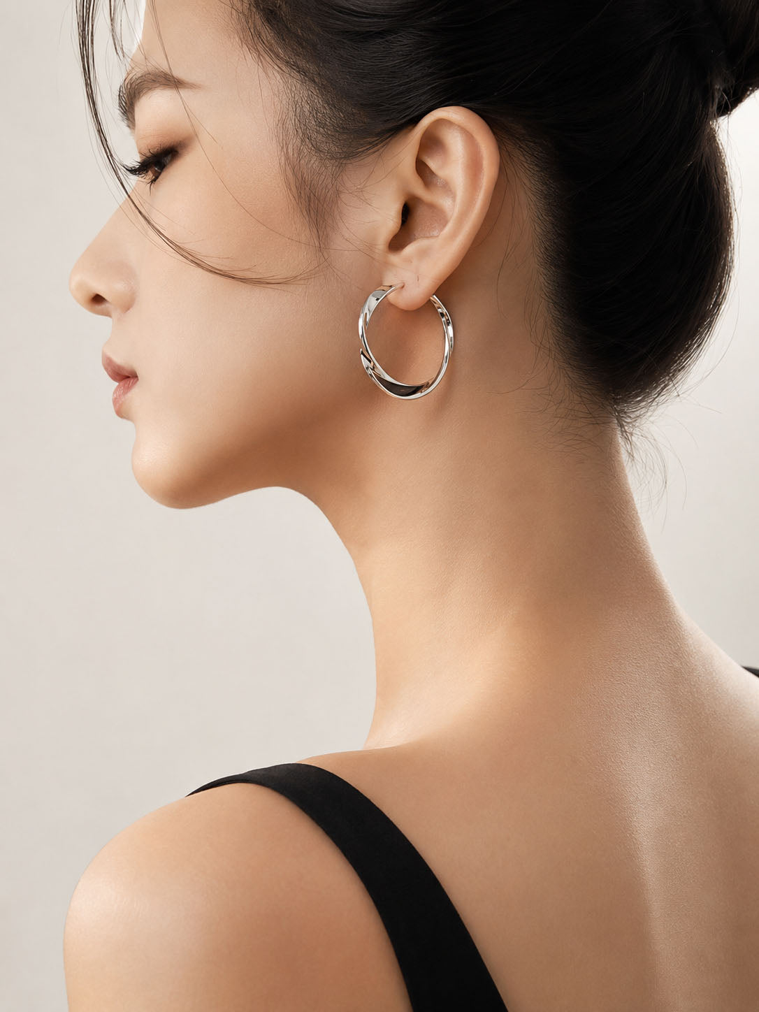 Pair of silver hoop earrings on a white background