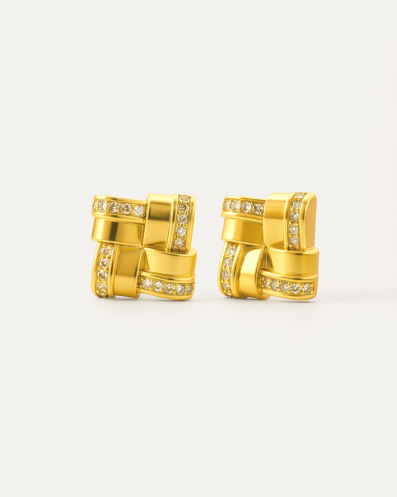18K gold-plated interlocked square crystal stud earrings on minimalist background
