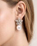 Ivory Bloom pearl drop earrings with cubic zirconia floral design on-ear model view