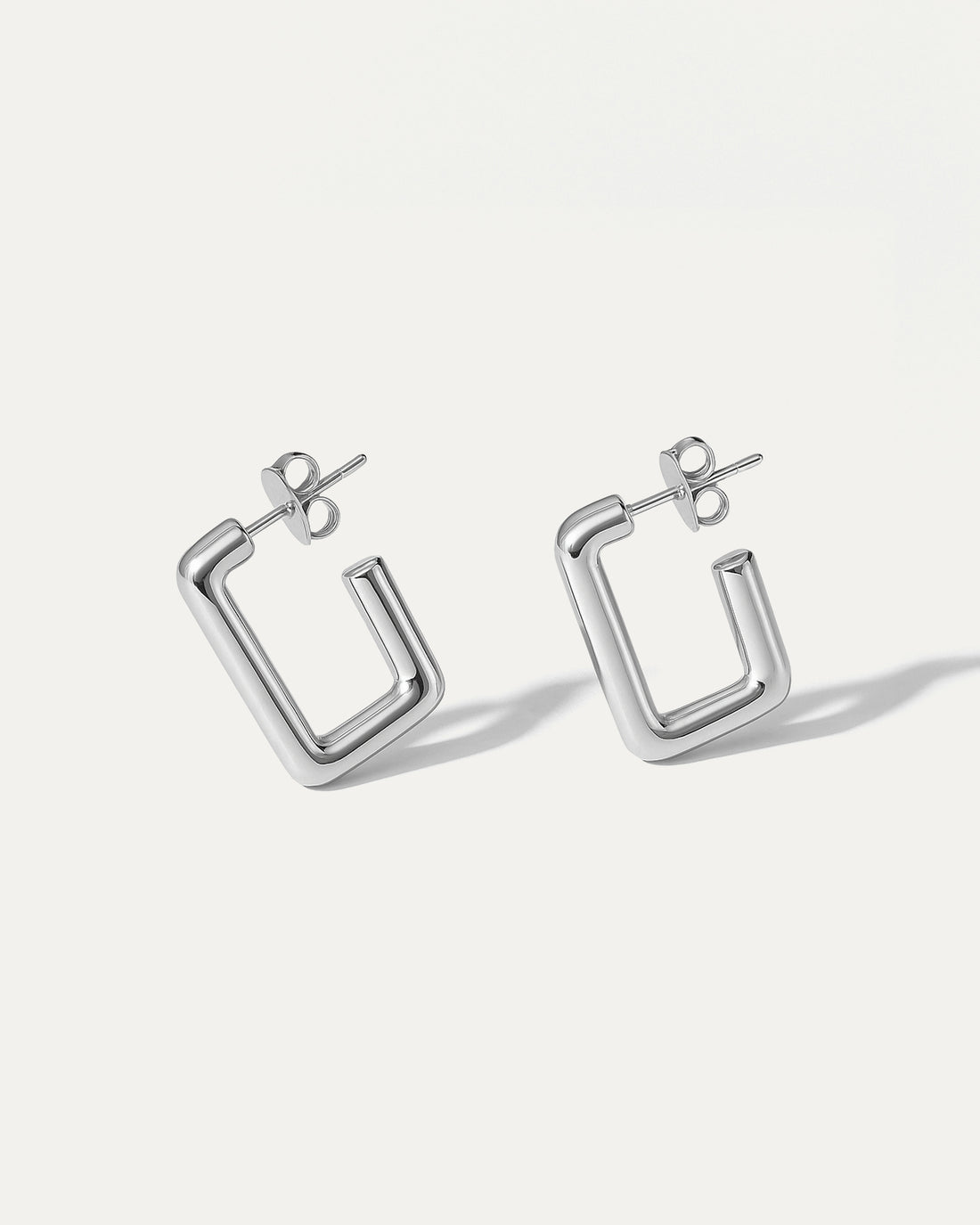 Silver hoop earrings on a white background