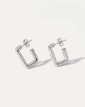Pair of silver hoop earrings on a white background