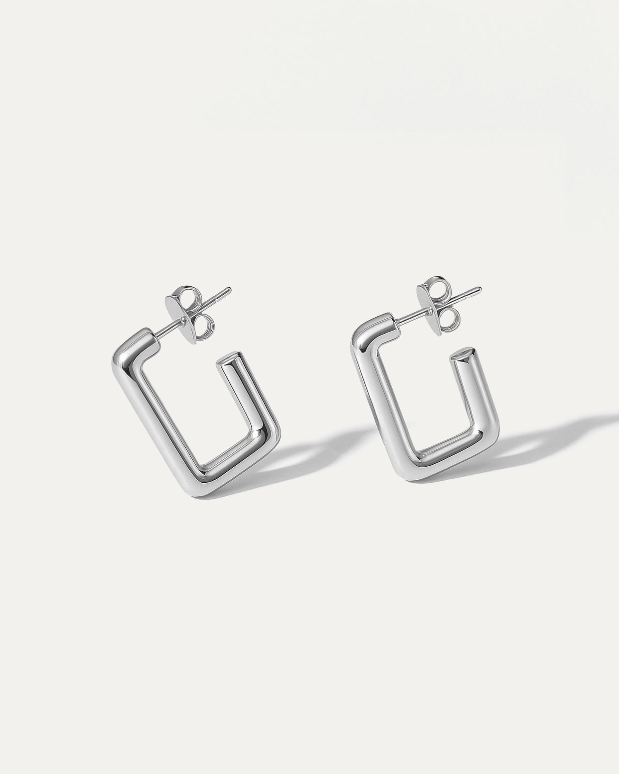 Pair of silver hoop earrings on a white background