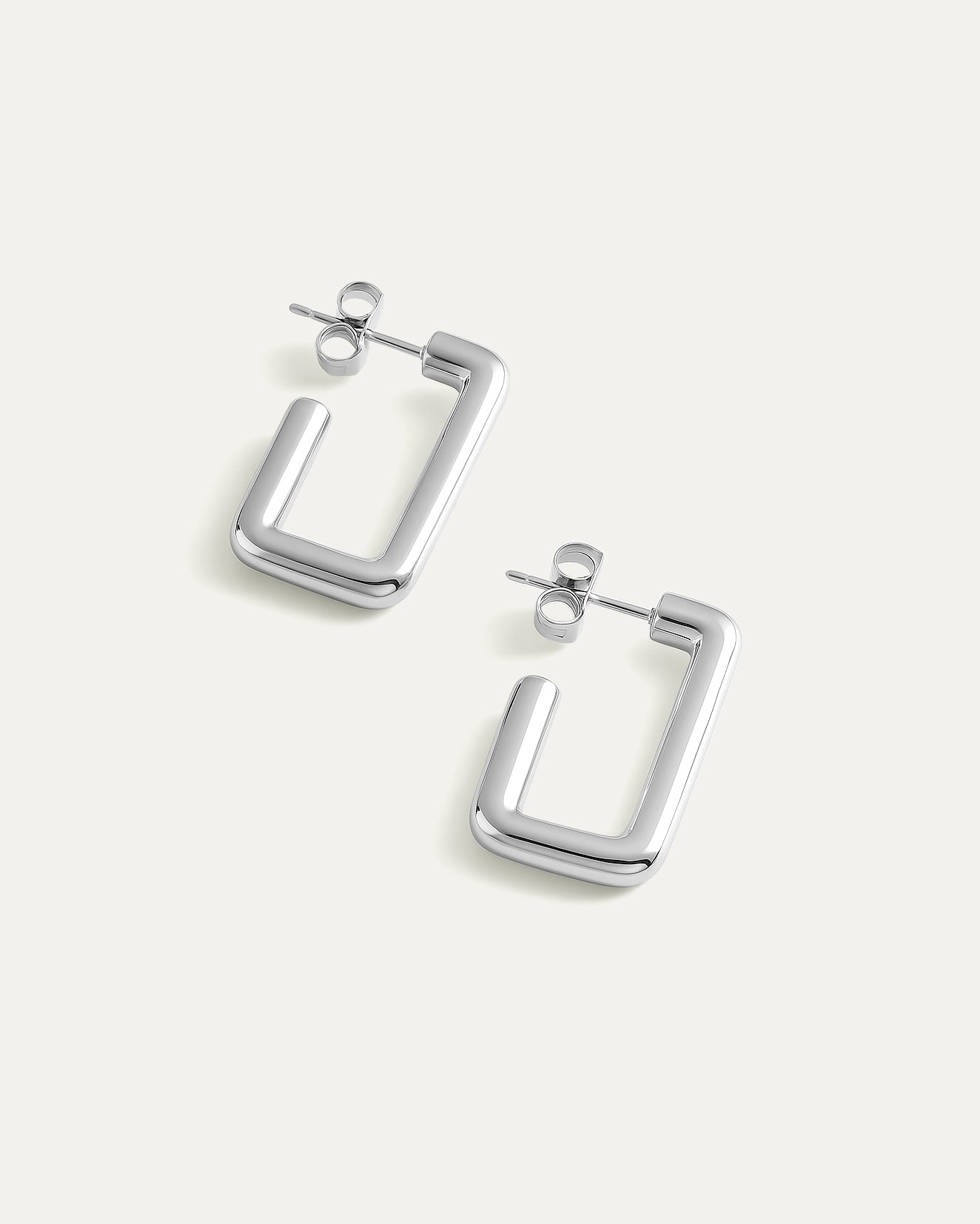 Pair of silver hoop earrings on a white background