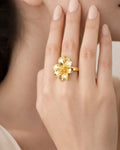 18K gold-plated floral statement ring on model hand, elegant minimalist jewelry