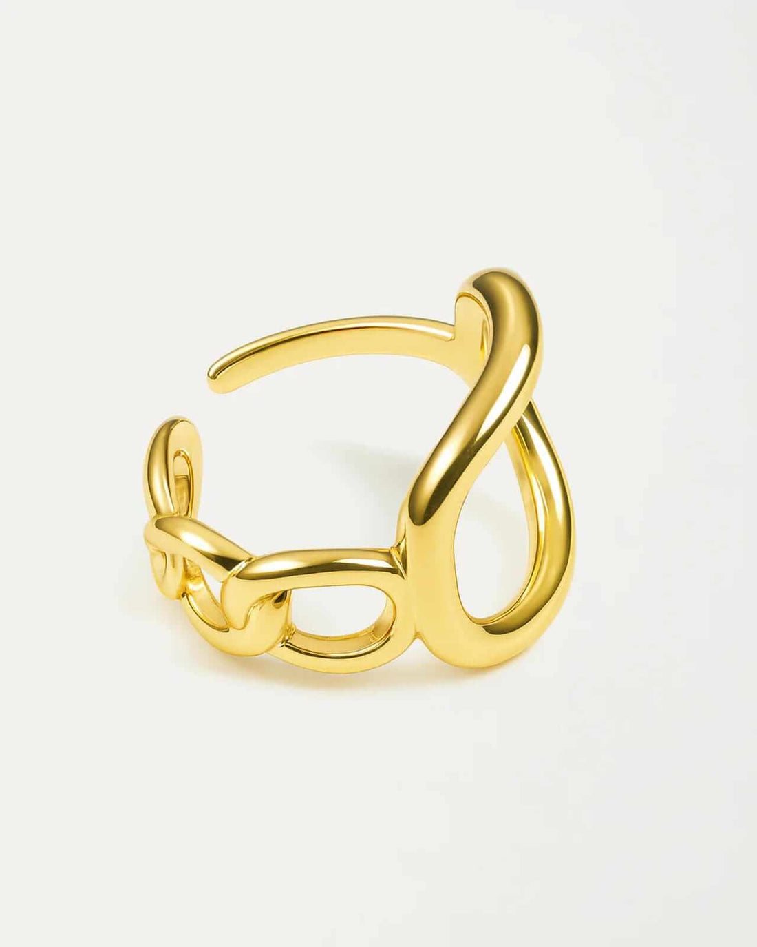 Gold ring with a twisted design on a light gray background