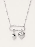 Silver necklace with heart-shaped pendants on a white background