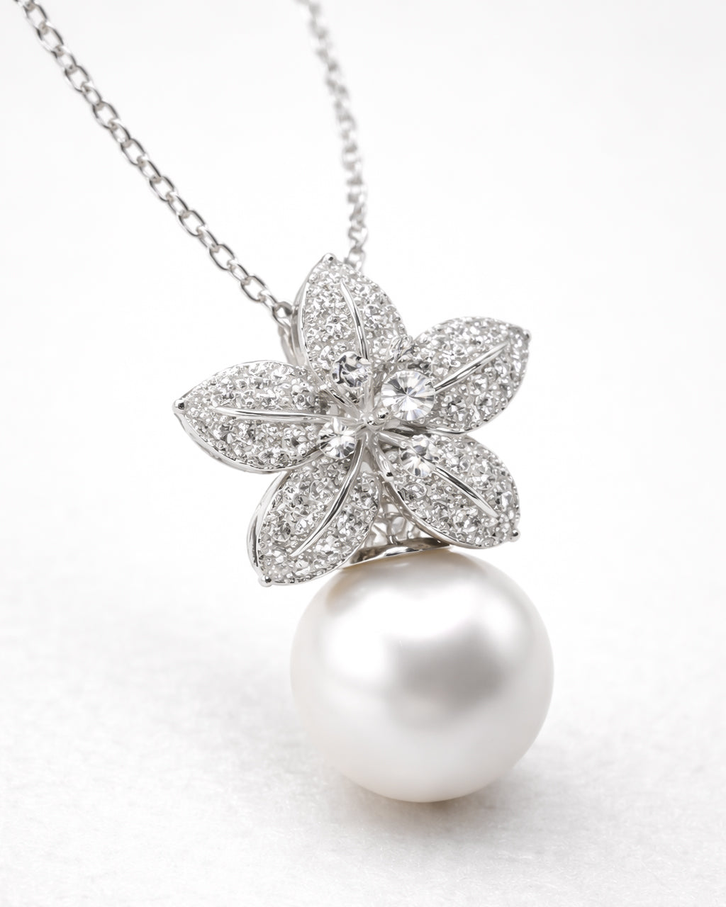 Pearl drop flower pendant necklace with zircon stones, gold plated 45 degree angle view