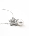 Pearl drop flower pendant necklace with zircon stones, gold plated side flat lay