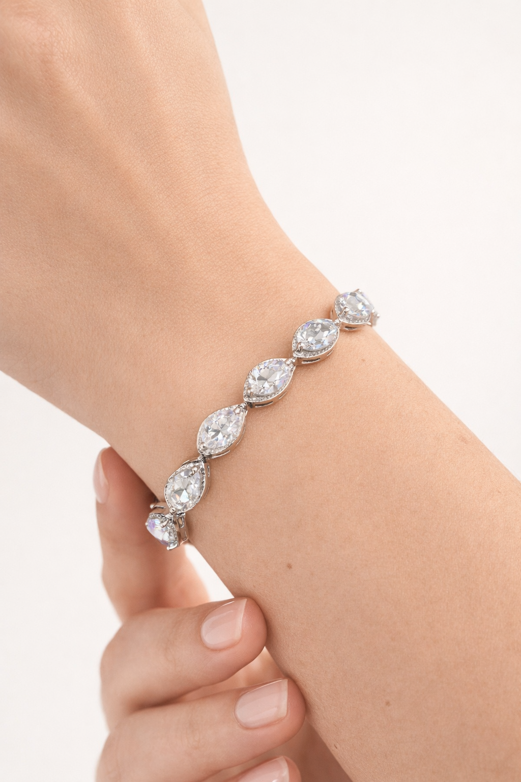 Lumière drop tennis bracelet on wrist with clear zircon stones, silver plated