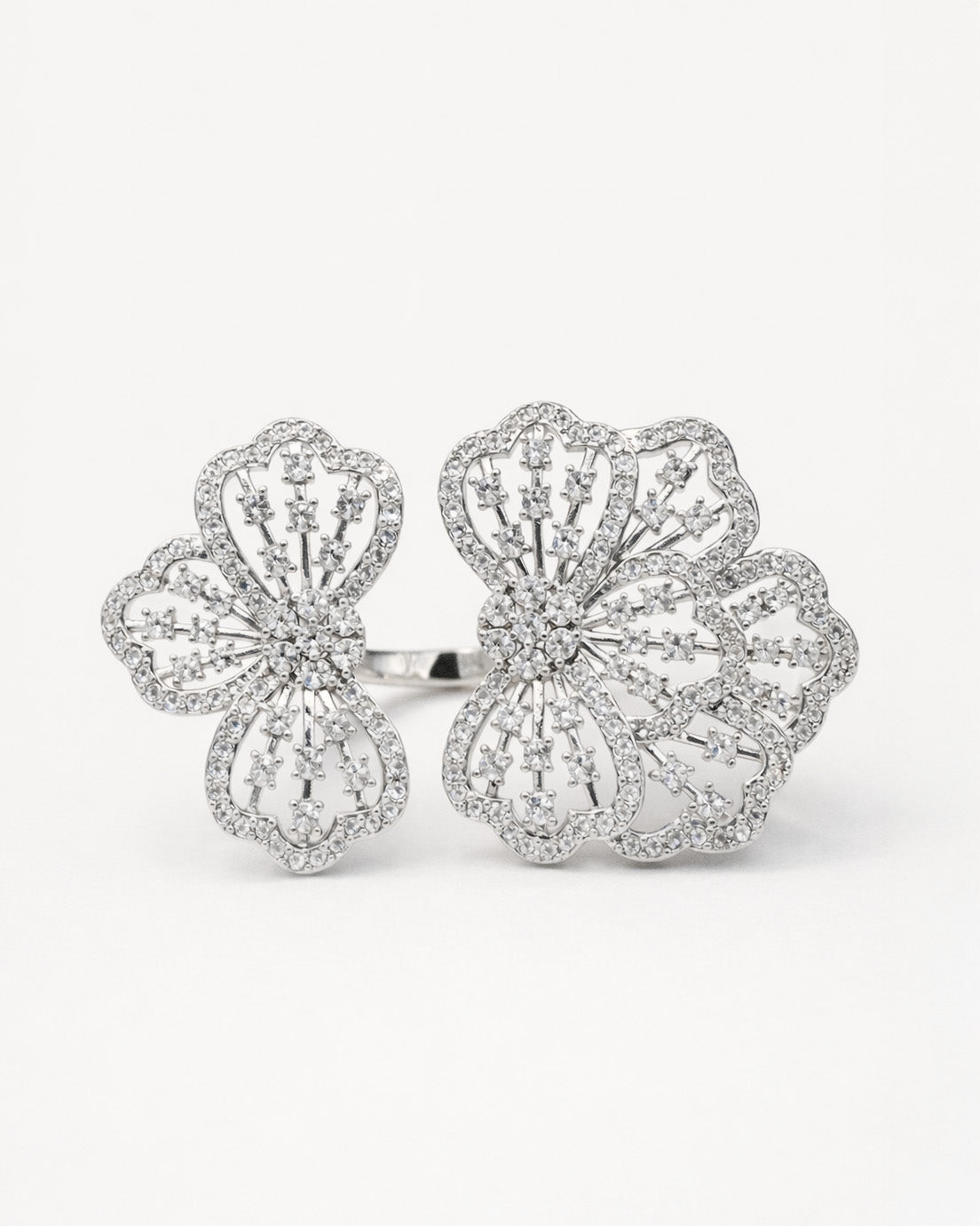 Floral adjustable silver ring with zircon stones, elegant openwork flower front view