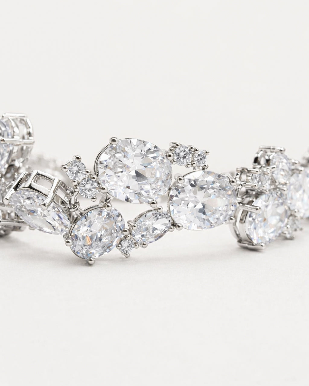 Oval CZ tennis bracelet in silver plated finish with sparkling stones, close-up view