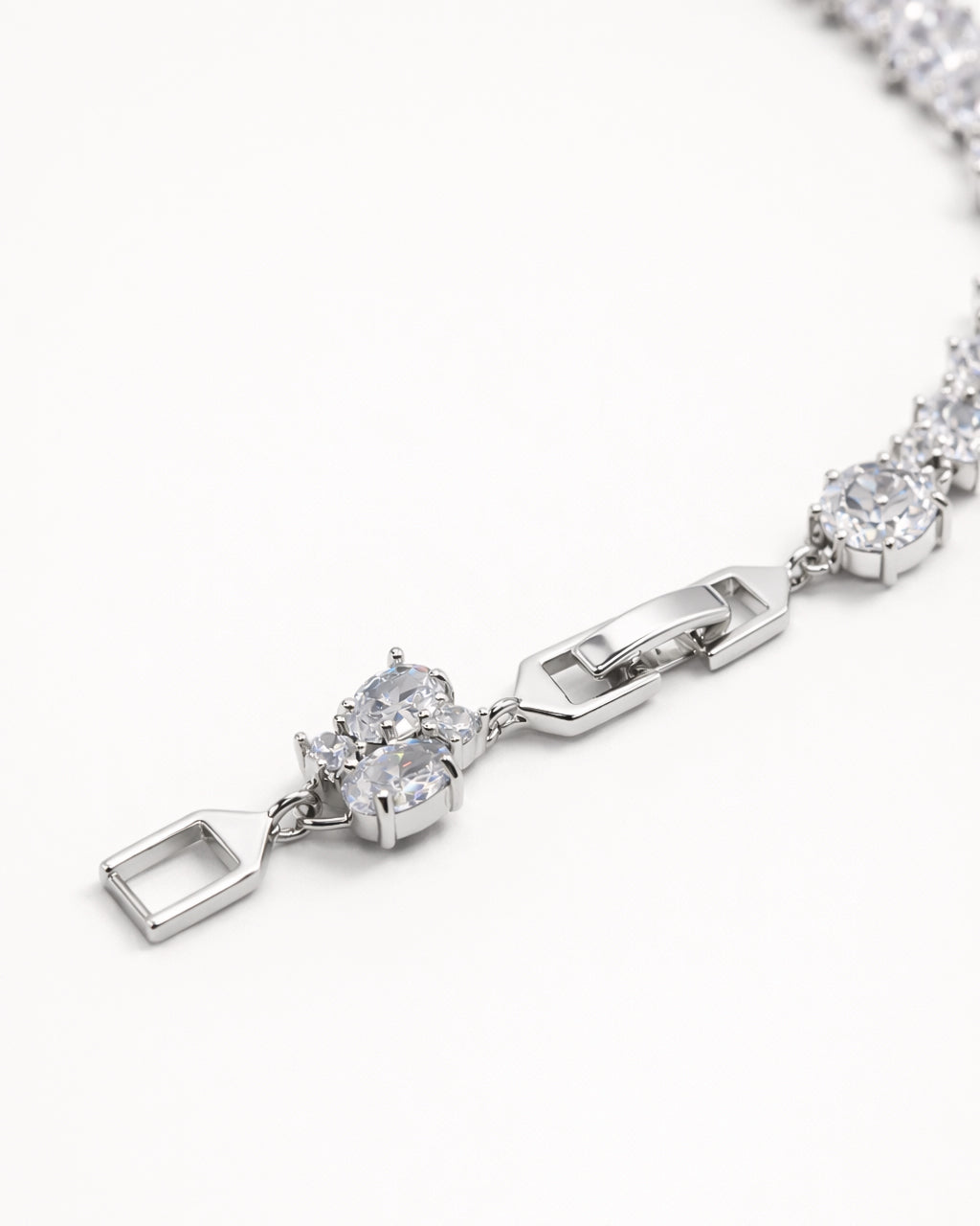 Oval CZ tennis bracelet in silver plated finish with secure clasp, close-up detail