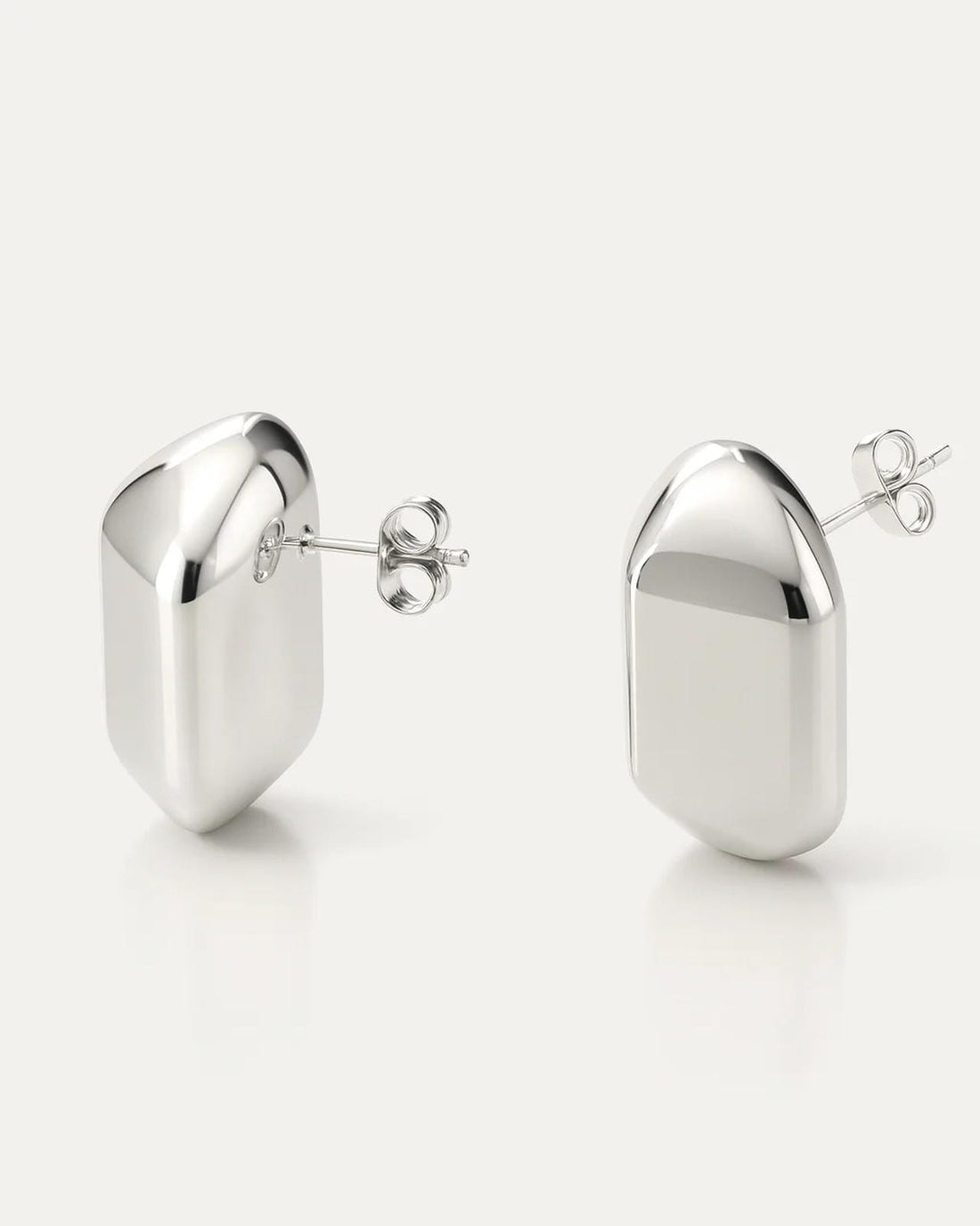 Silver-plated brass dome-shaped stud earrings with high-polish finish on neutral background