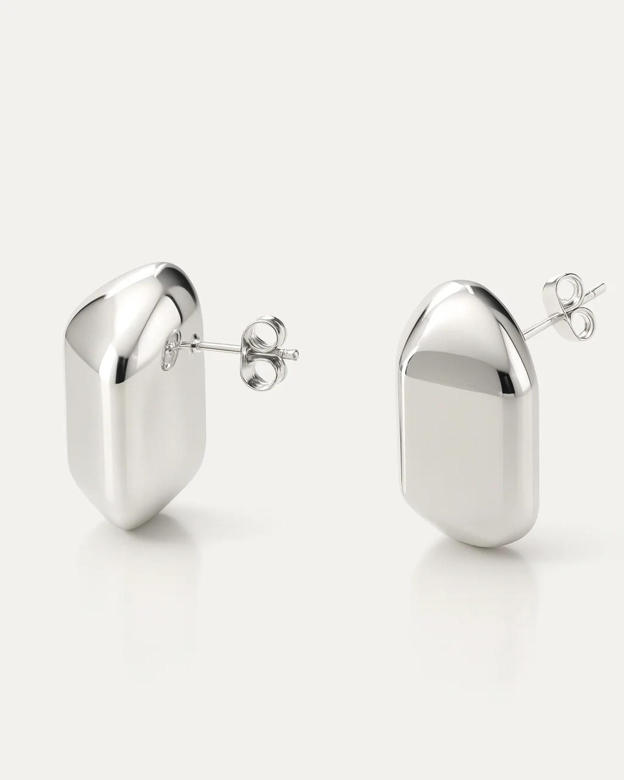 Silver-plated brass dome-shaped stud earrings with high-polish finish on neutral background