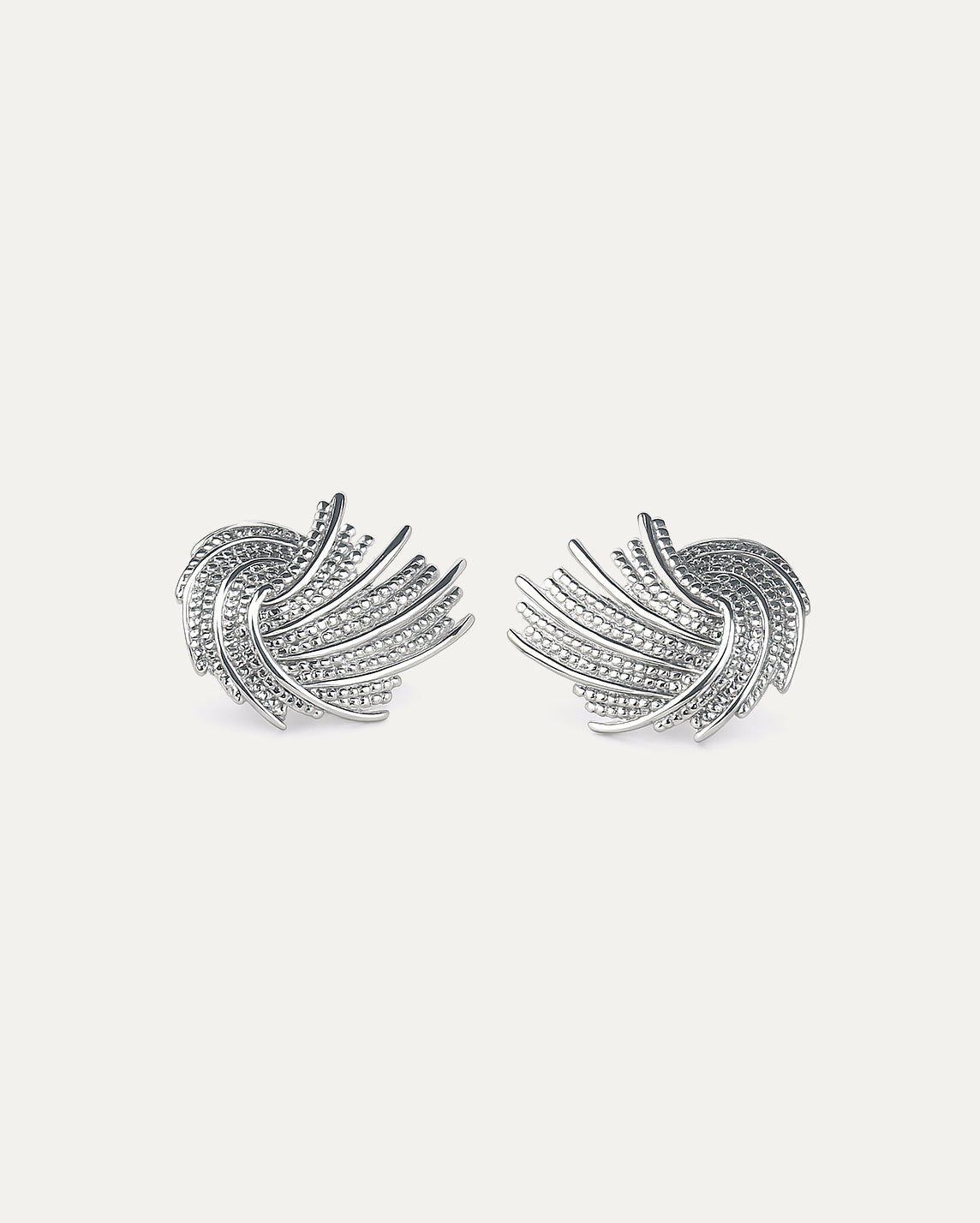 Pair of silver feather-shaped earrings on a light gray background