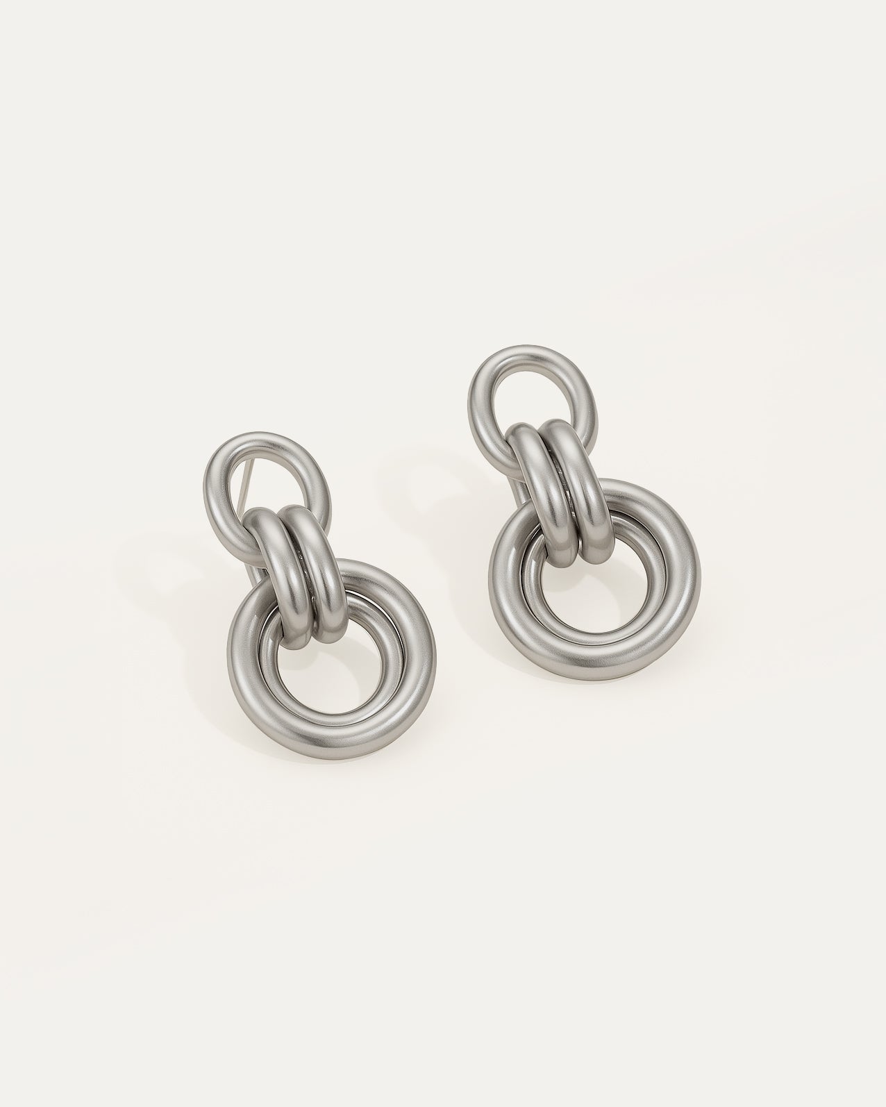Pair of silver chain-link earrings on a white background