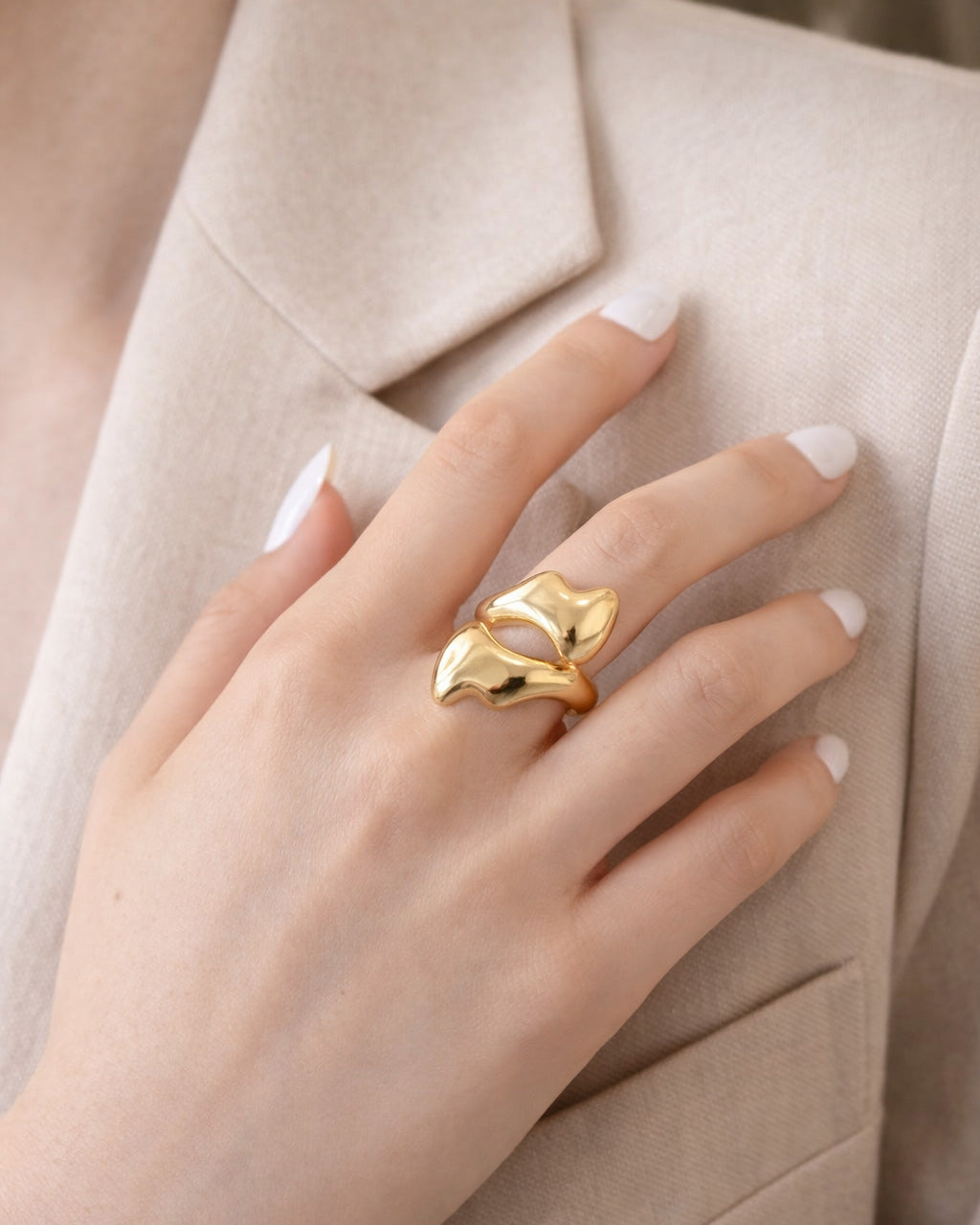 18K gold-plated melted flow statement ring worn on model hand, modern sculptural design