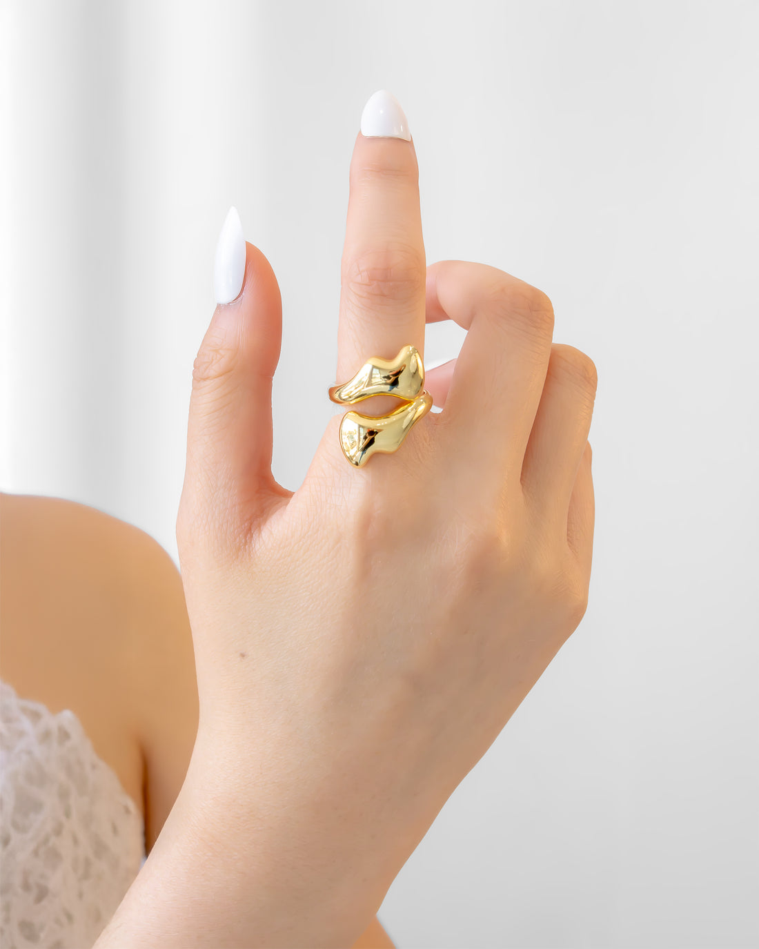 Gold statement ring with fluid melted design and open-front structure
