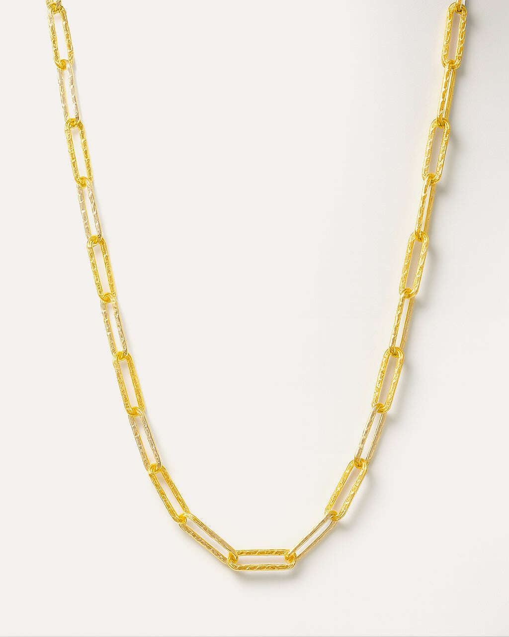 Gold chain necklace on a white background