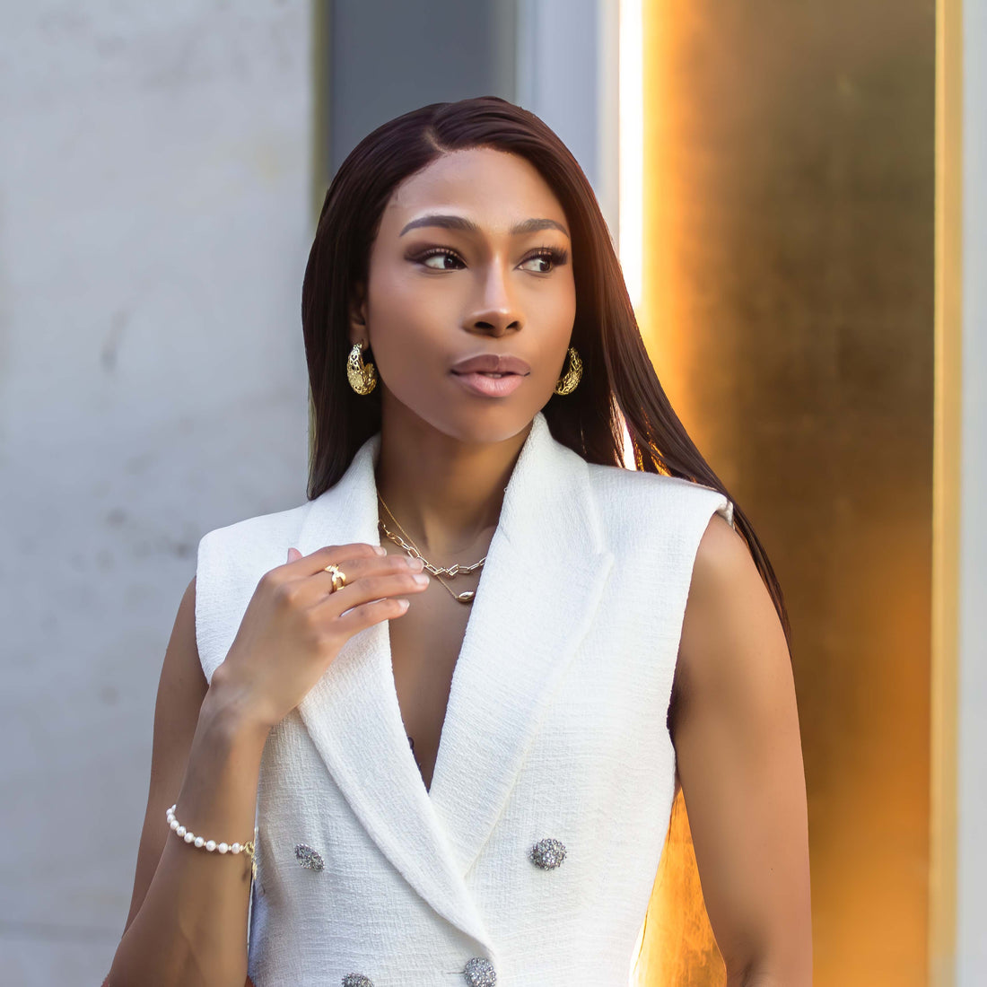 Minimalist women’s jewelry styled on model with gold earrings necklace lifestyle fashion