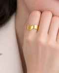 18k gold plated minimalist wave ring worn on hand, modern women’s jewelry style