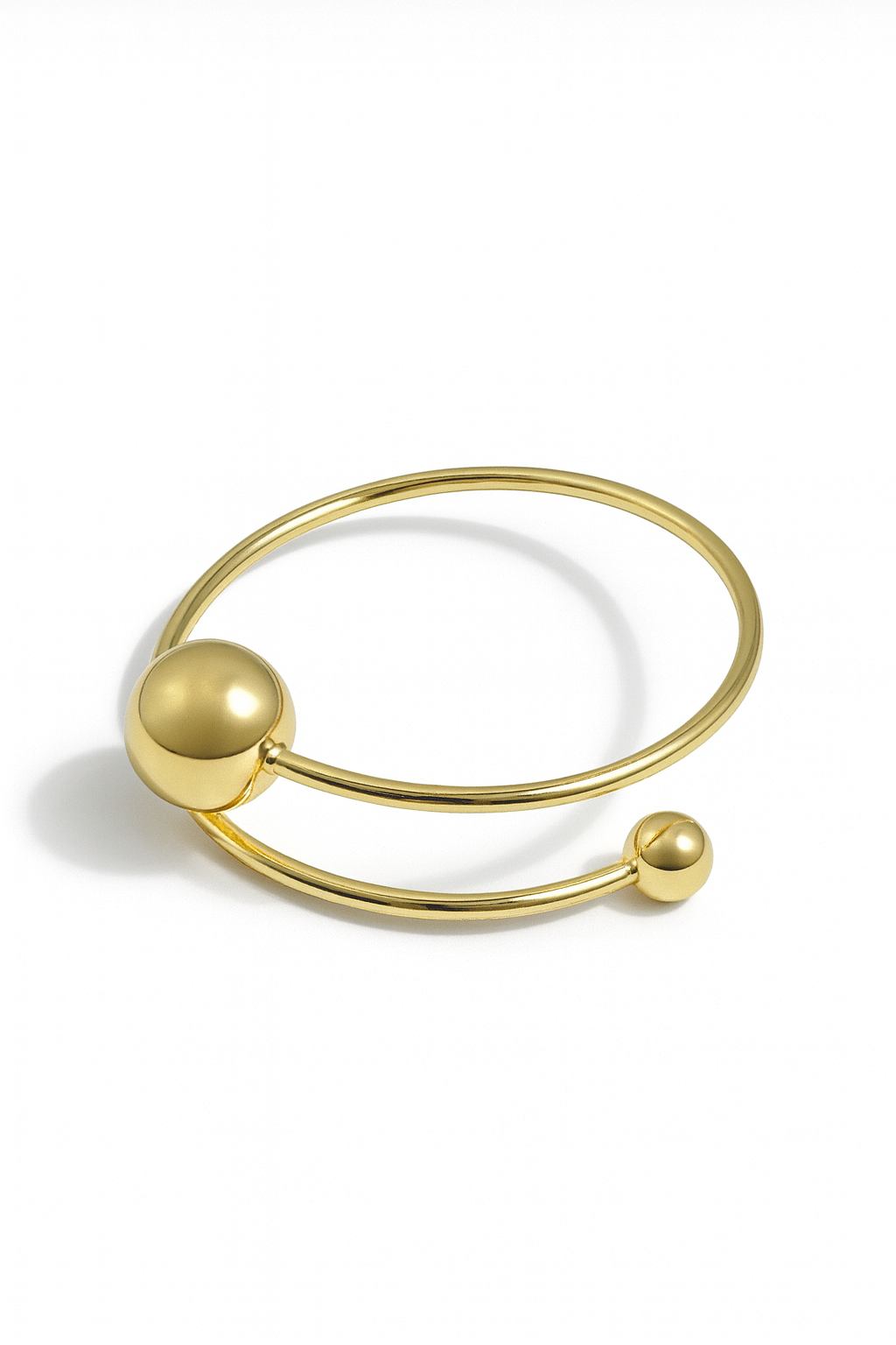 Orbit Dual Sphere Cuff – 18K gold-plated brass bracelet with two polished spheres, modern open cuff design.
