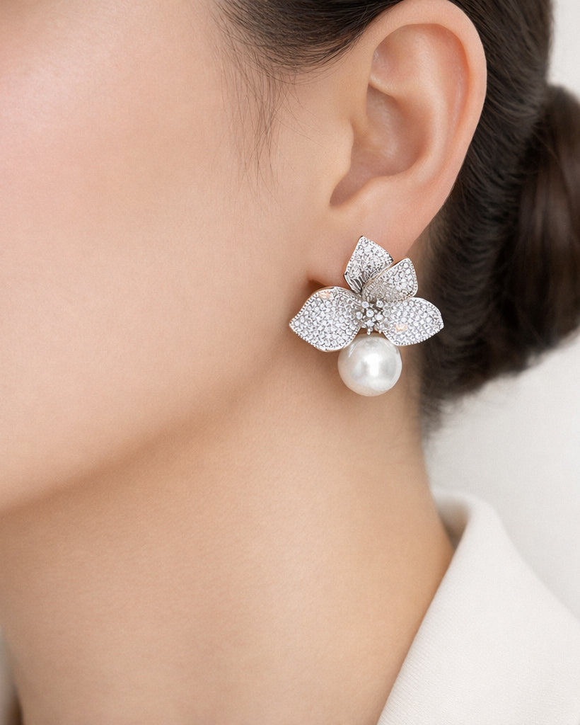 Silver floral pearl drop earrings on ear with cubic zirconia accents for women
