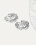 Pair of silver hoop earrings on a white background