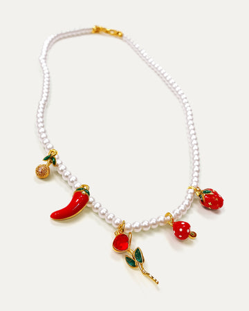 Pearl necklace with colorful fruit charms on a white background