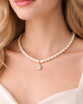 Pearl choker necklace with crystal teardrop pendant worn by model, 18k gold plated