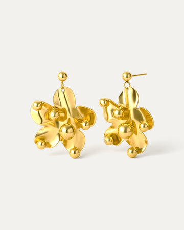 Gold abstract earrings on a white background