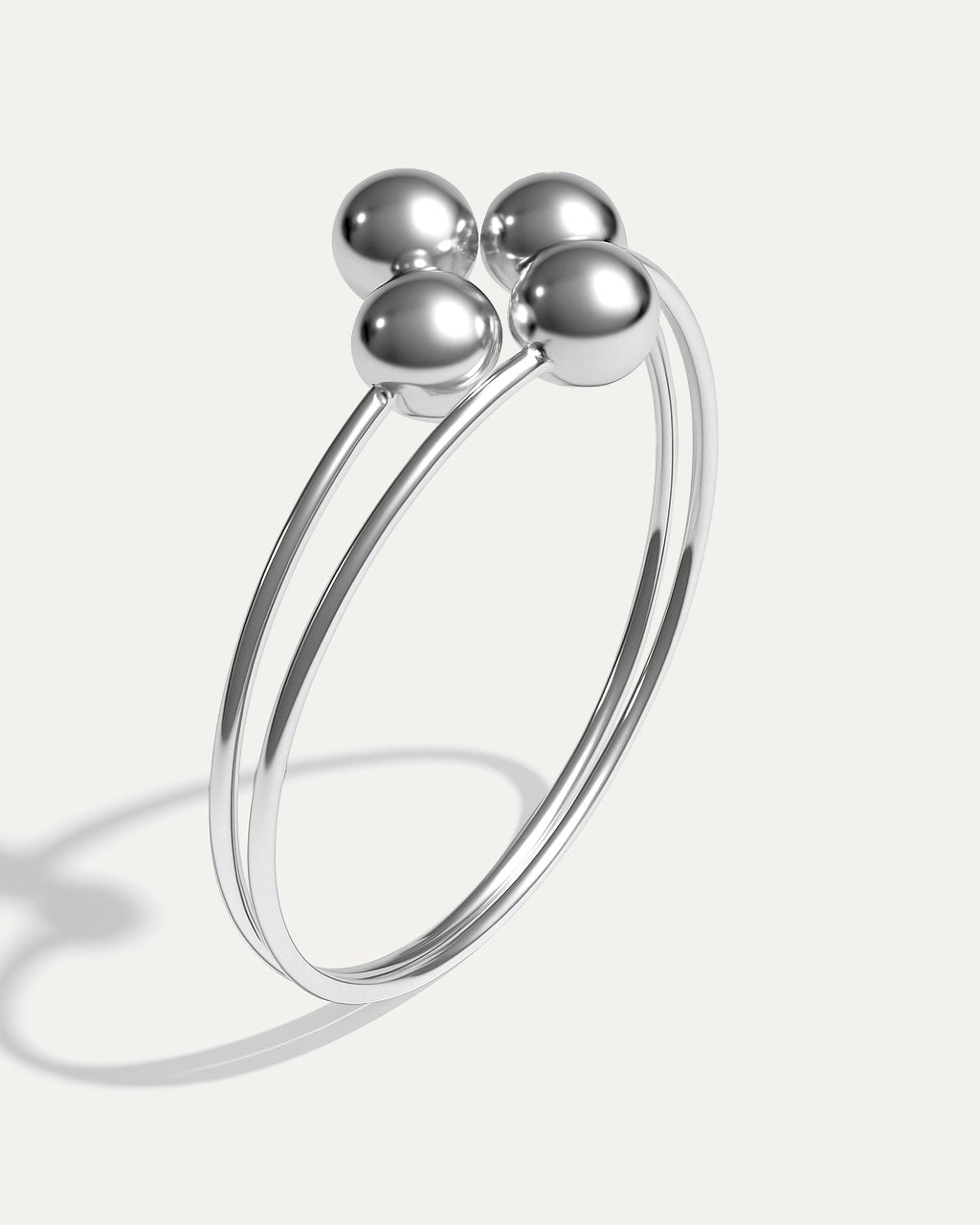 Minimal silver cuff with four polished spheres – Quad Sphere Bracelet.