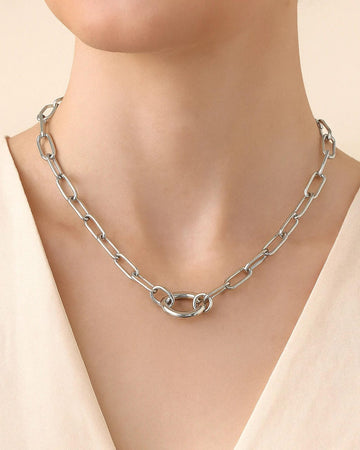 Silver chain necklace on a mannequin with a beige background