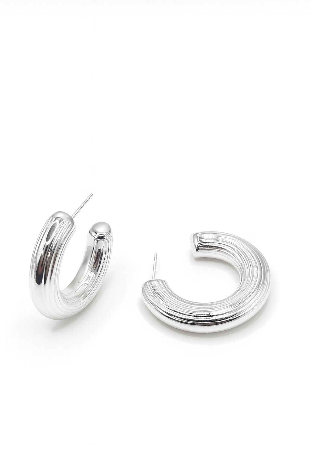 Silver hoop earrings on a white background