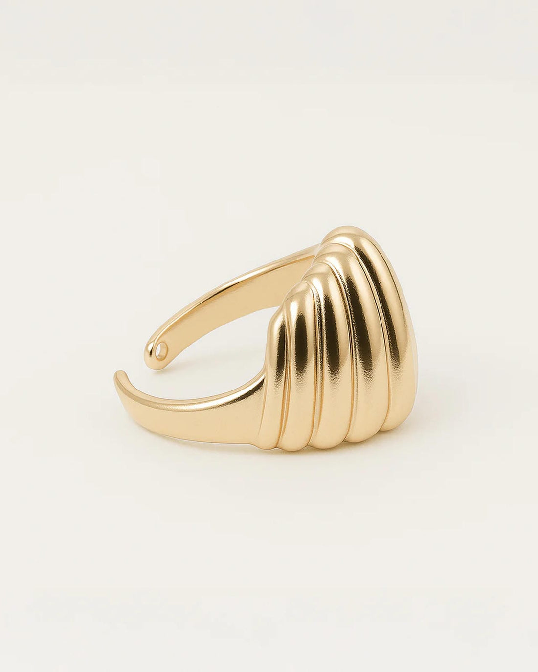 Gold statement ring with smooth sculpted ridges and dome-like shell design