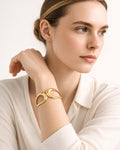 Elegant model wearing 18K gold-plated ripple cuff bracelet minimalist women jewelry