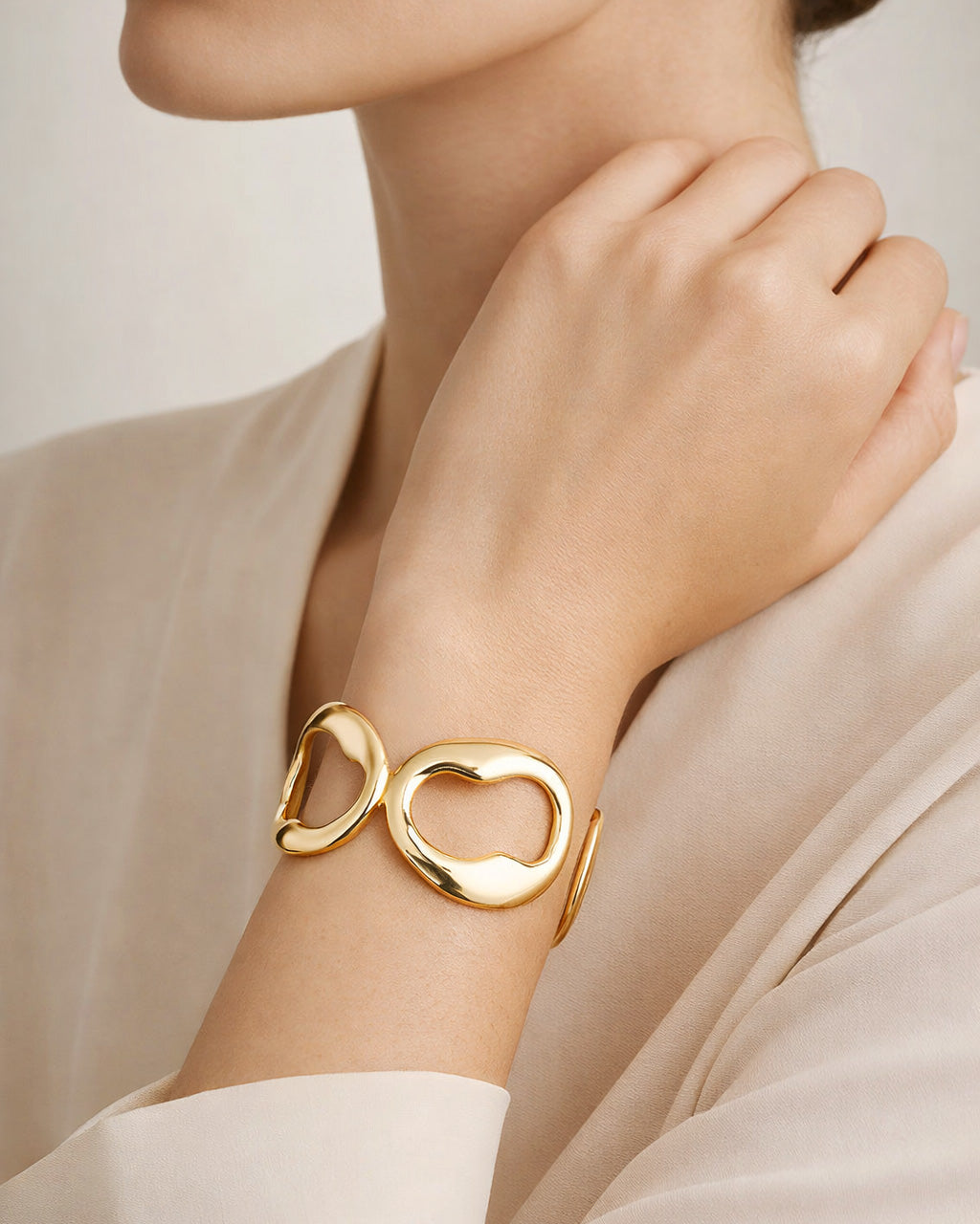Elegant model wearing 18K gold-plated ripple circle cuff bracelet minimalist jewelry