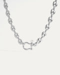 Silver chain necklace with a heart-shaped clasp on a light gray background