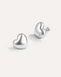 Silver heart-shaped earrings on a white background