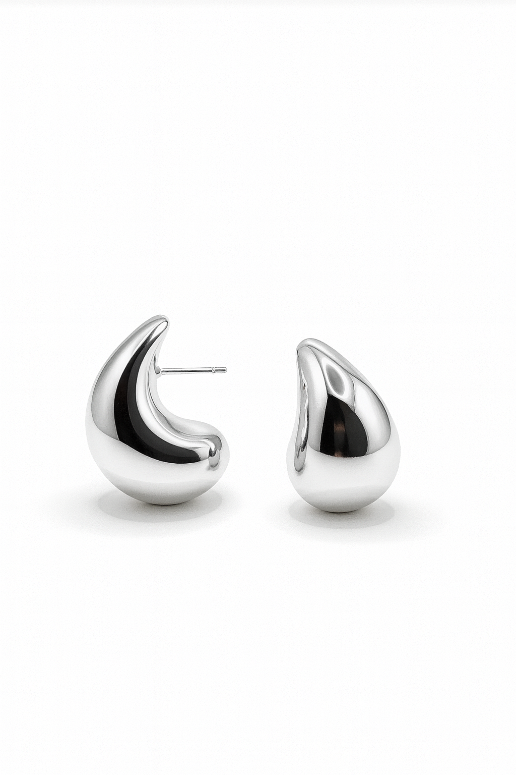 Silver sculpted teardrop-shaped stud earrings with smooth high-polish finish