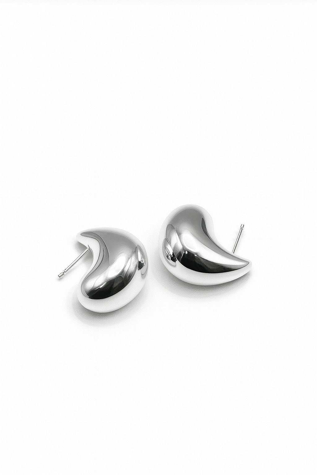 Silver sculpted teardrop-shaped stud earrings with smooth high-polish finish