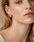 Model wearing 18K gold-plated semi striped stud earrings, modern minimalist women’s jewelry