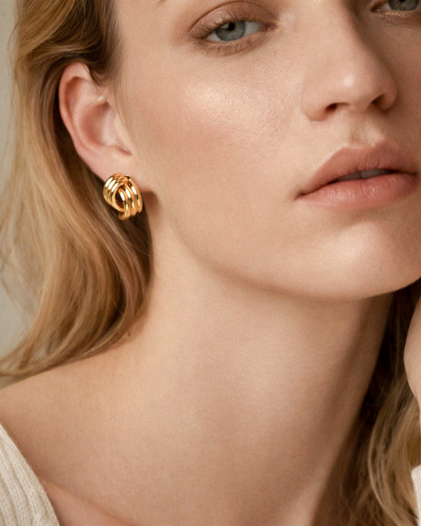 Model wearing 18K gold-plated semi striped stud earrings, modern minimalist women’s jewelry