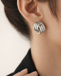 Sterling silver semi striped stud earrings on model, modern minimalist jewelry look