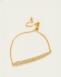 A gold-plated slider bracelet with a delicate box chain and an adjustable ball closure. The centerpiece is a serpent-like bar