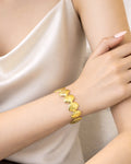 18K gold-plated shell cuff bracelet on model wrist, elegant minimalist jewelry