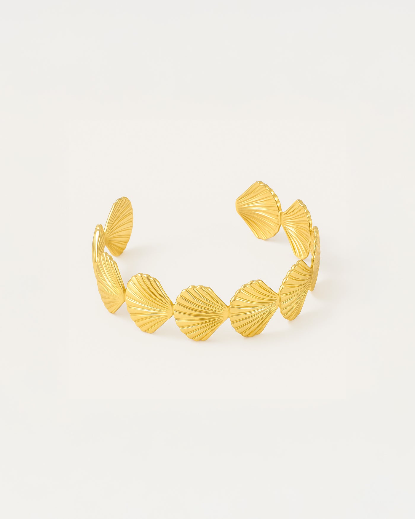 Elegant gold-plated seashell cuff bracelet with ridged fan-shaped design and open-ended style